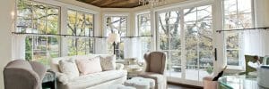wood panelled ceiling in a white living room with chandelier