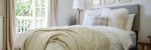 scandinavian-inspired-white-bedroom-with-plush-bedding-and-white-washed-gallery-wall