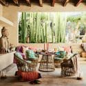 Asian-inspired covered patio with colorful textiles and wicker furniture