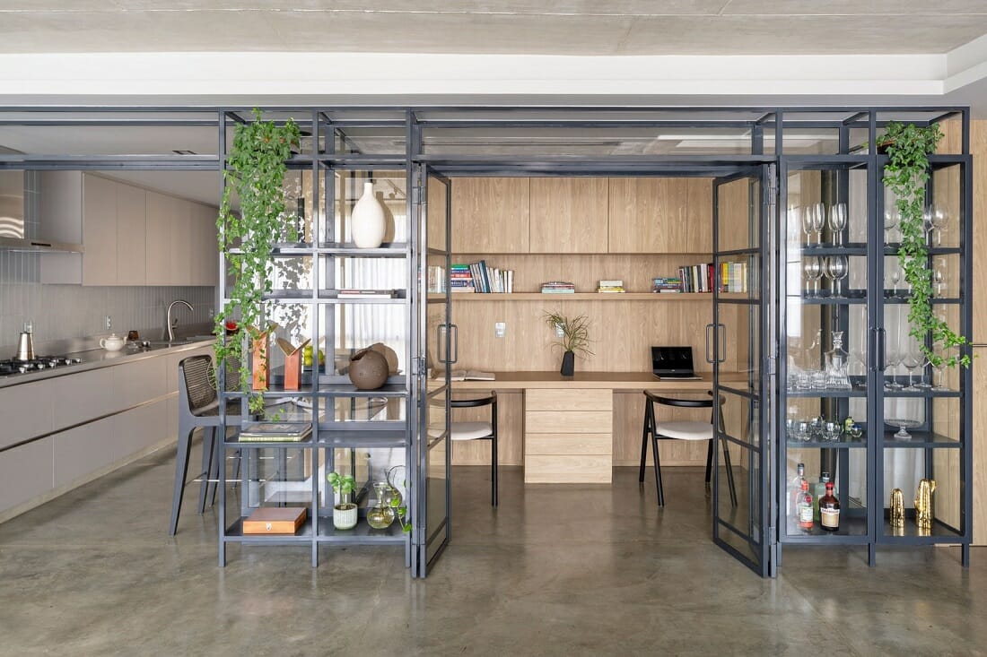 Home office next to the kitchen separated only by glass panels