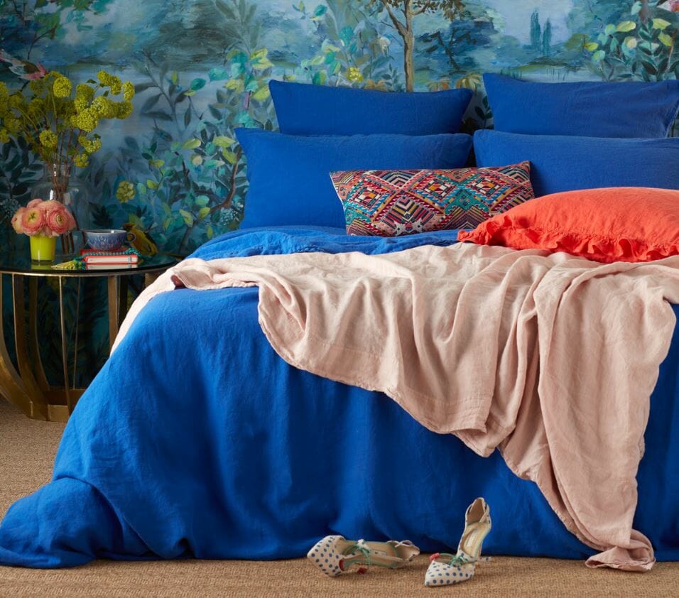 Blue bedroom with pops of orange styled by interior stylist Sophie Robinson