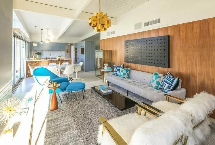 Mid century interior design living and dining area with blue and gold accents