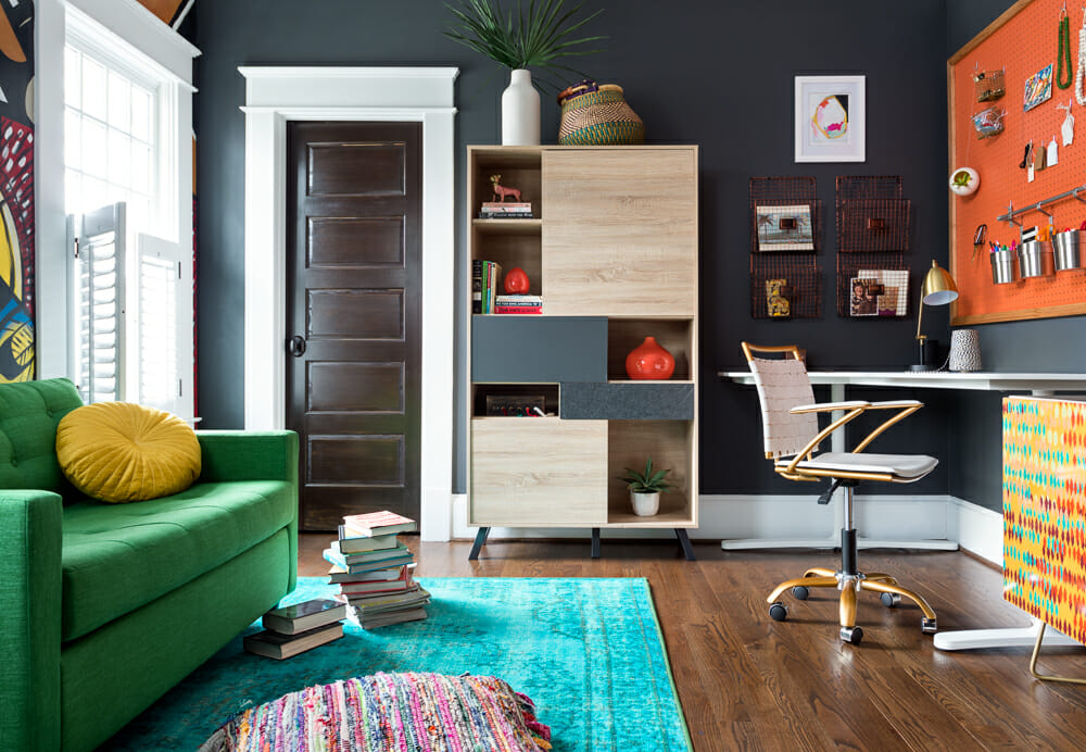Colorful home study room interior design with a dark grey feature wall and orange and green accents by Gina Sims