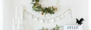 Light and minimal chic halloween decor above a mantelpiece