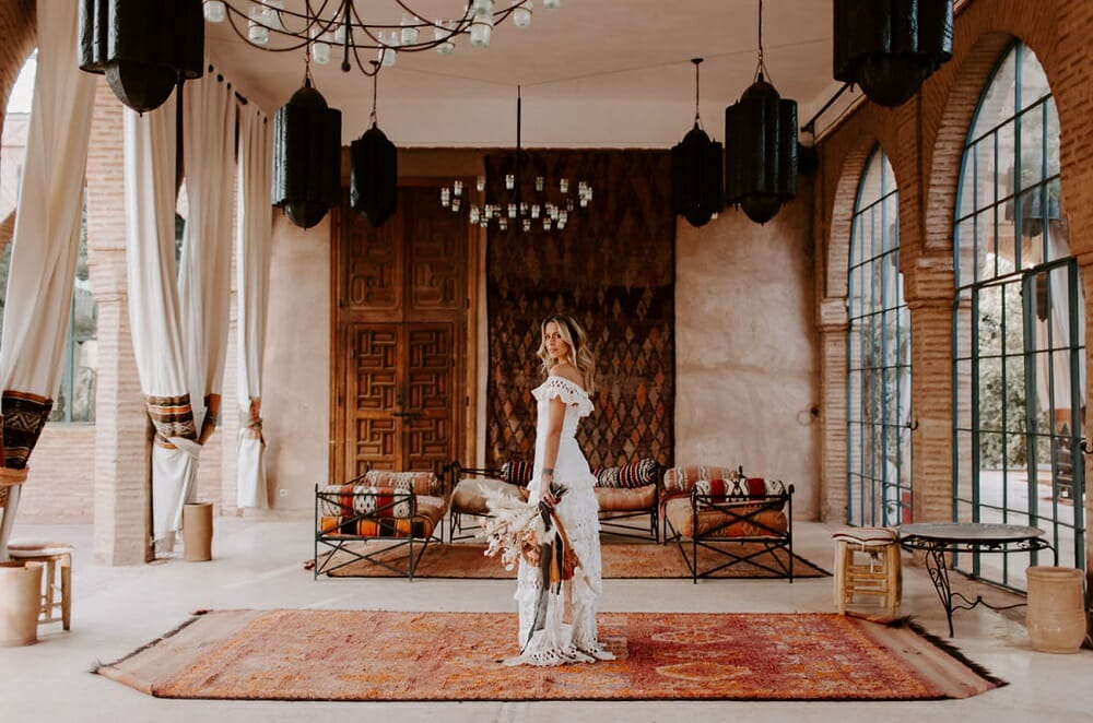 Bride with a bohemian wedding dress style in a Moroccan outdoor lounge