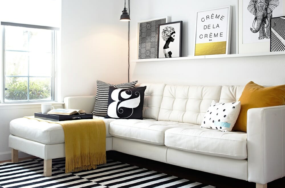 Floating shelves in a black and white lounge - tips on how to make a room look bigger