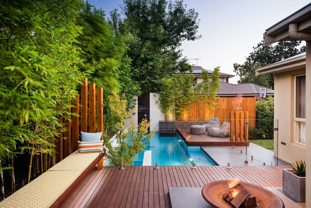 luxury pool with poolside furniture and screens - houzz