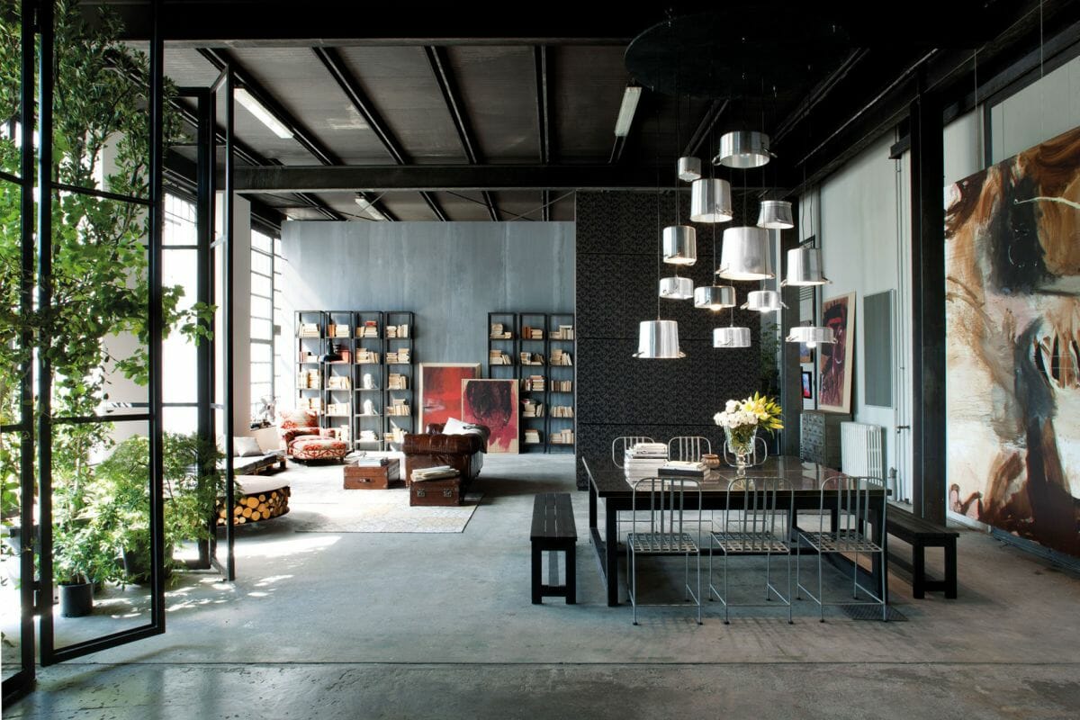 Large open concept interior filled with industrial decor and wall decor - homedit