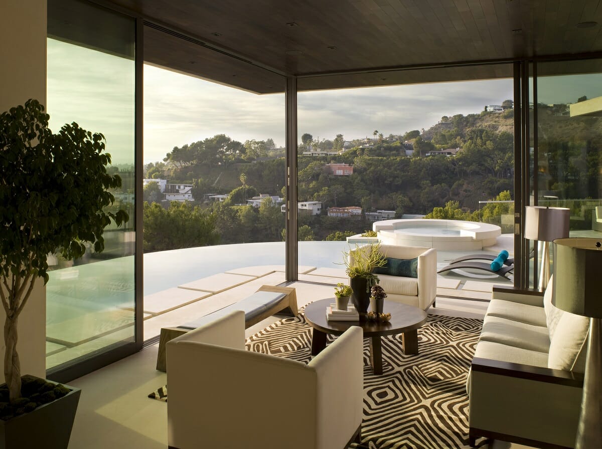 Living room with a poolside view by celebrity interior designer Lori D