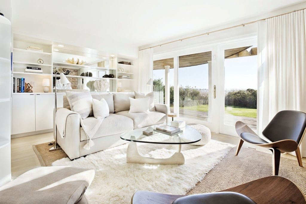 Discrete white curtains in a Scandinavian living room by Decorilla designer, Peter C.