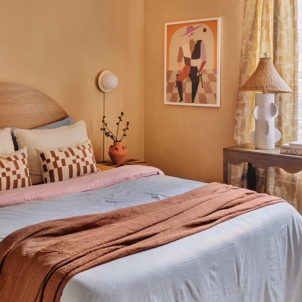 How to hang patterned curtains like in a cozy artistic bedroom by Decorilla designer, Maja E.