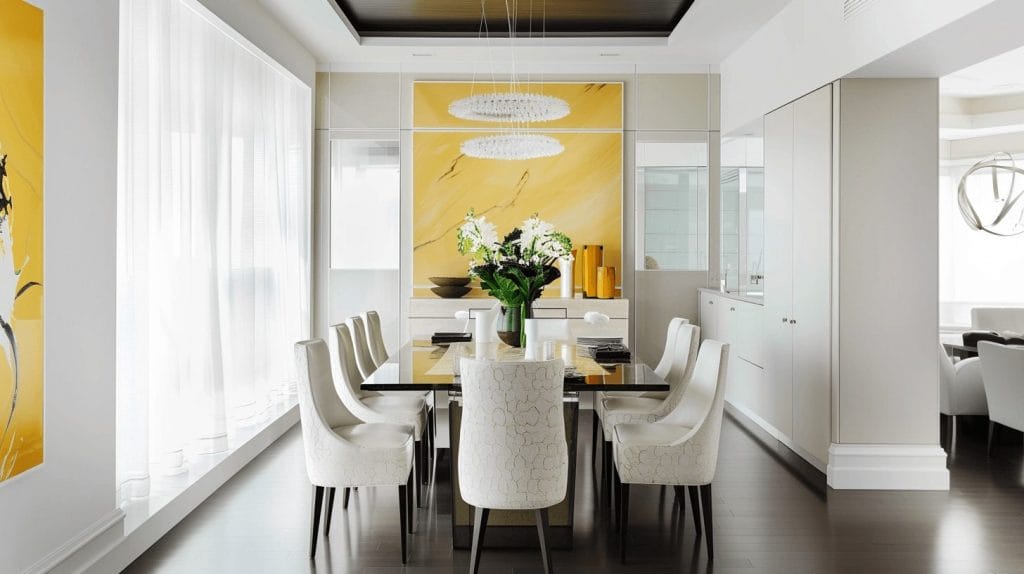 Yellow accents in a modern dining room by Decorilla