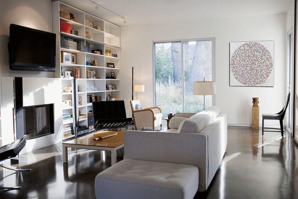 Typical tall shelving and Scandinavian decor in a library-home office by Decorilla designer, Renata P.