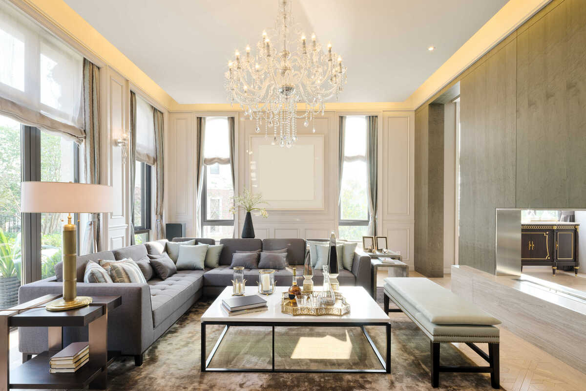 Transitional great room with a crystal chandelier by Decorilla