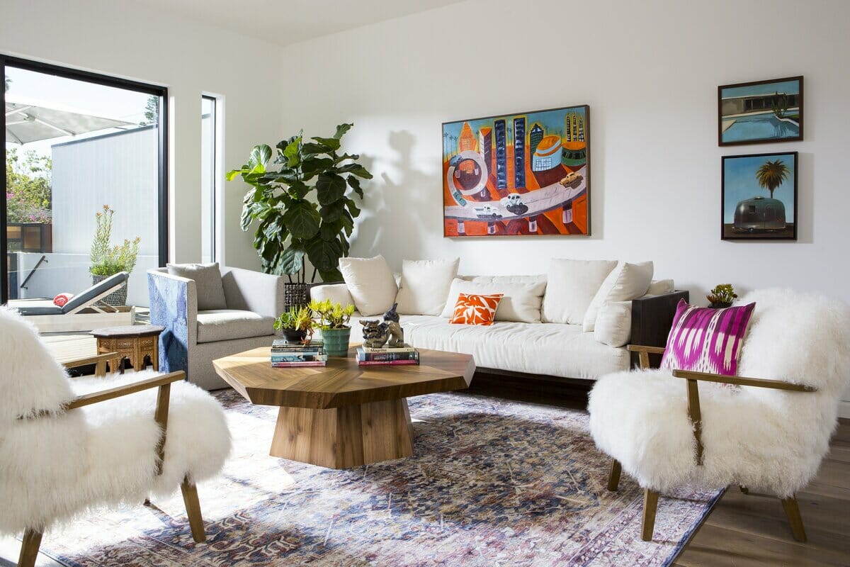 Jewel tone throw pillows and art in a living room by Decorilla designer Lori D
