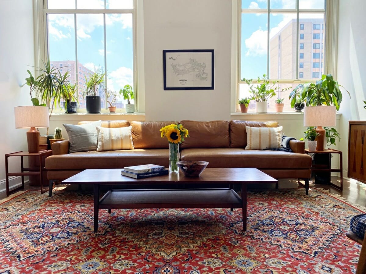 Natural wood decor and greenery in a living room by Amy C