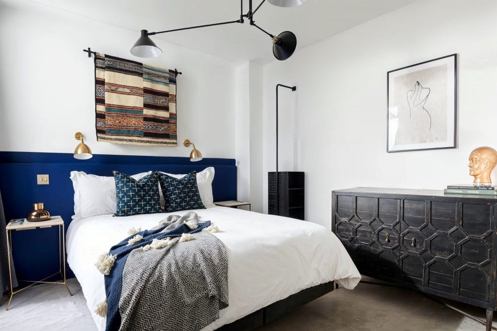 Boho bedroom vibes and custom headboard in an interior by Decorilla designer, Sarah R.
