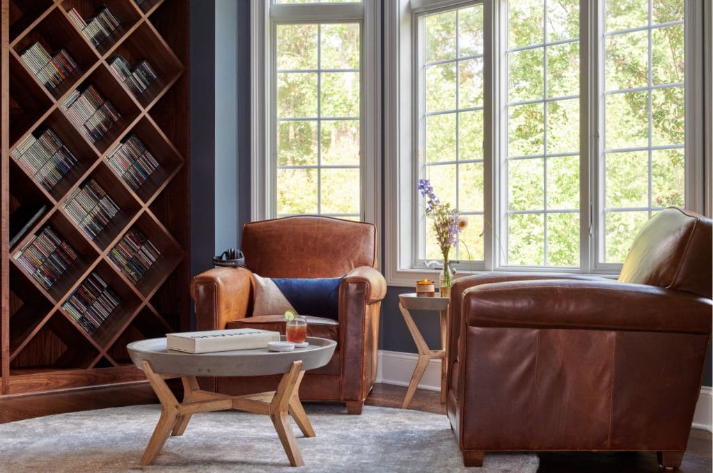 Cozy living room corner with a functional accent wall by Decorilla designer, Amy C.