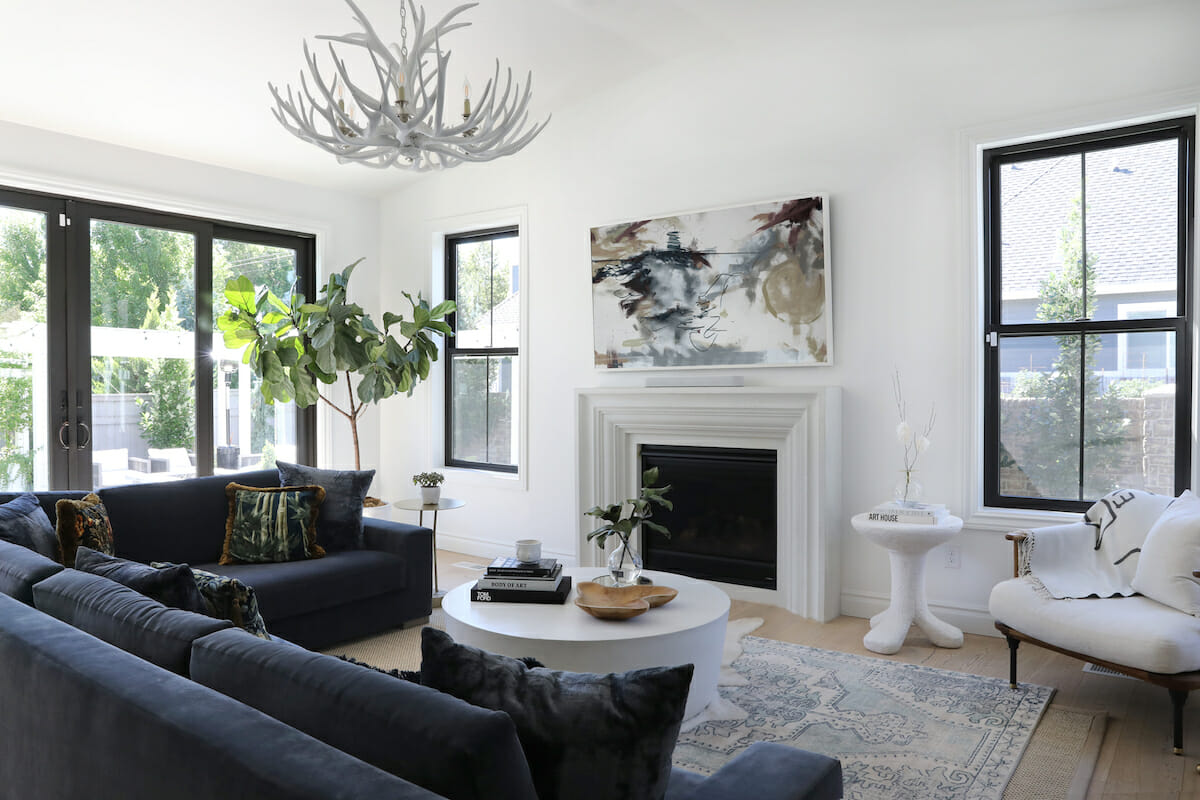 Decorilla designer Jamie C. arranges the furniture around the fireplace.