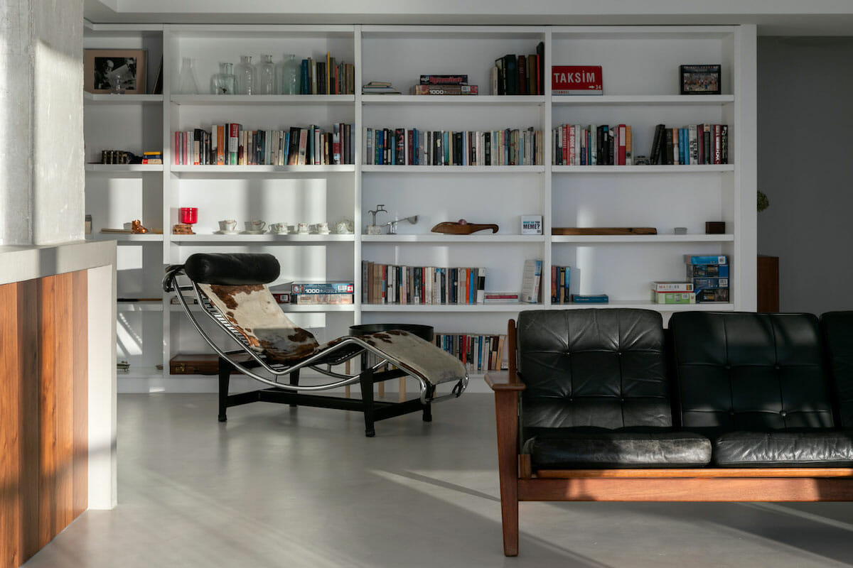 Black leather sofa in a modern living room by Decorilla desginer, Jasmine T.