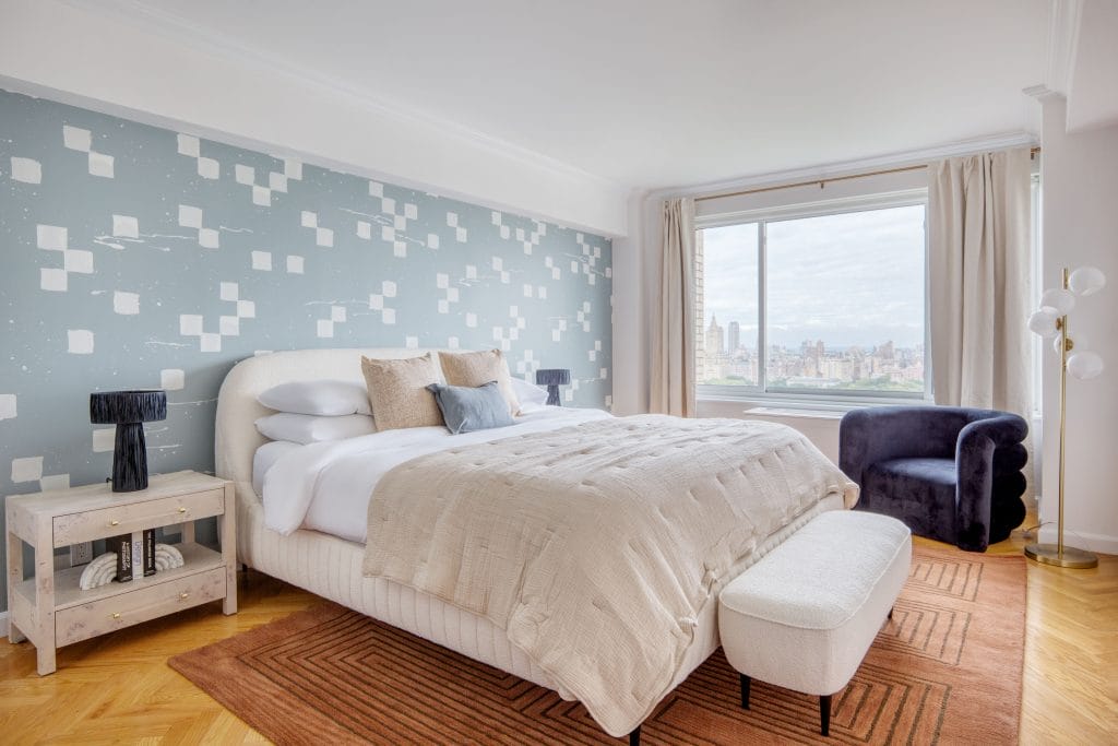 Master bedroom by Decorilla designer, Megan W., styled with a curved headboard