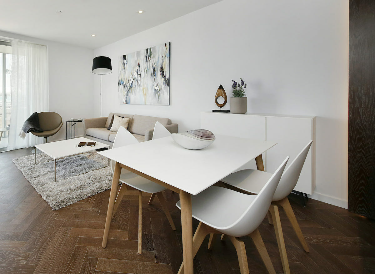 Simple Scandinavian dining room furniture in an open living space by Decorilla designer Katerina P.