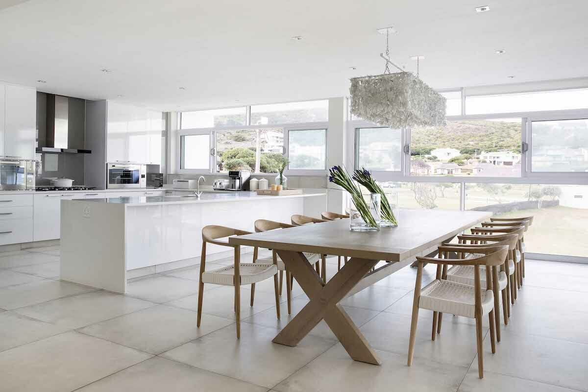 Sleek open living with Scandinavian dining table set by Decorilla designer, Anna C.