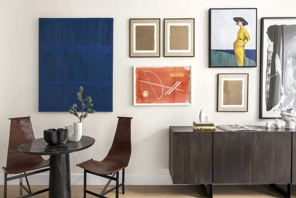 Artsy gallery wall ideas in a living room by Decorilla designer, Leanna S.