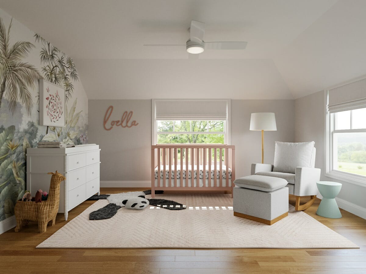 Jungle animal themed nursery with pink crib and jungle wallpaper