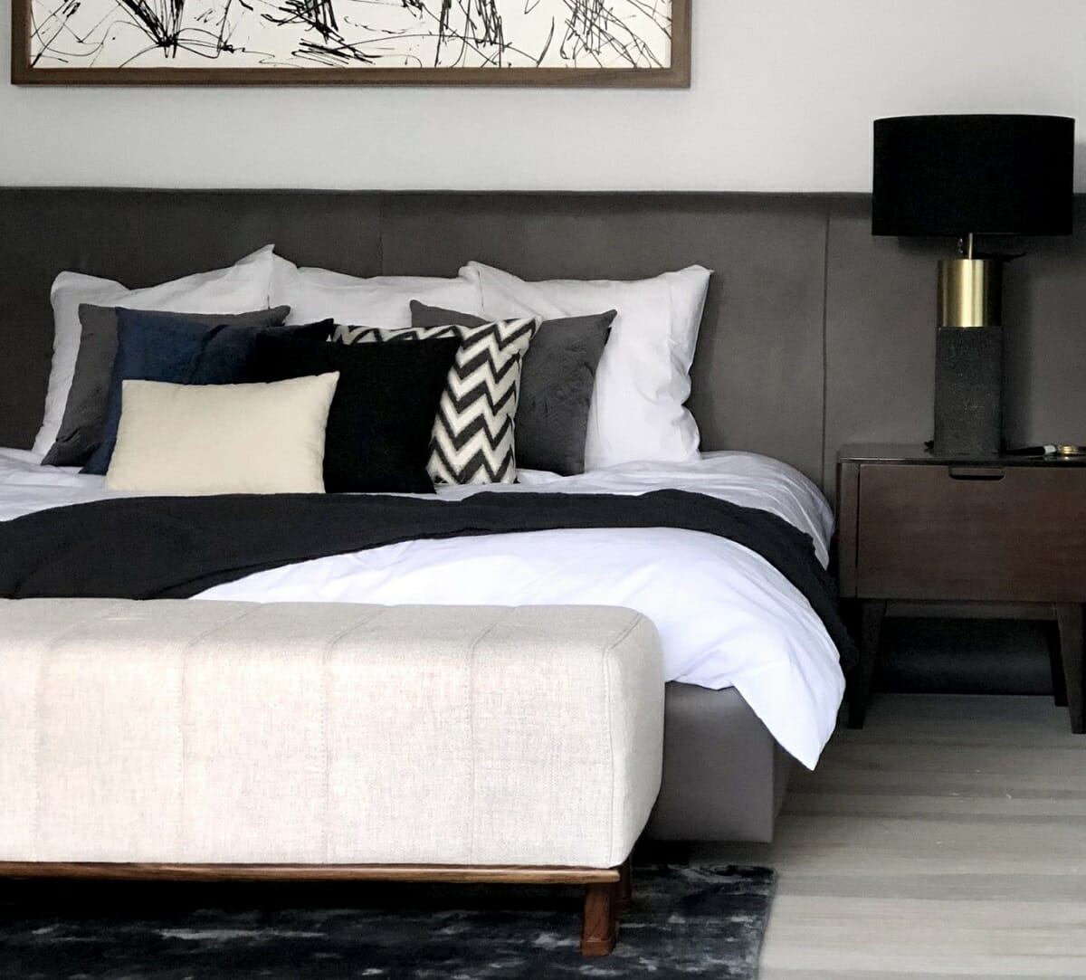 Simple king bed pillow arrangement with a black and white color scheme