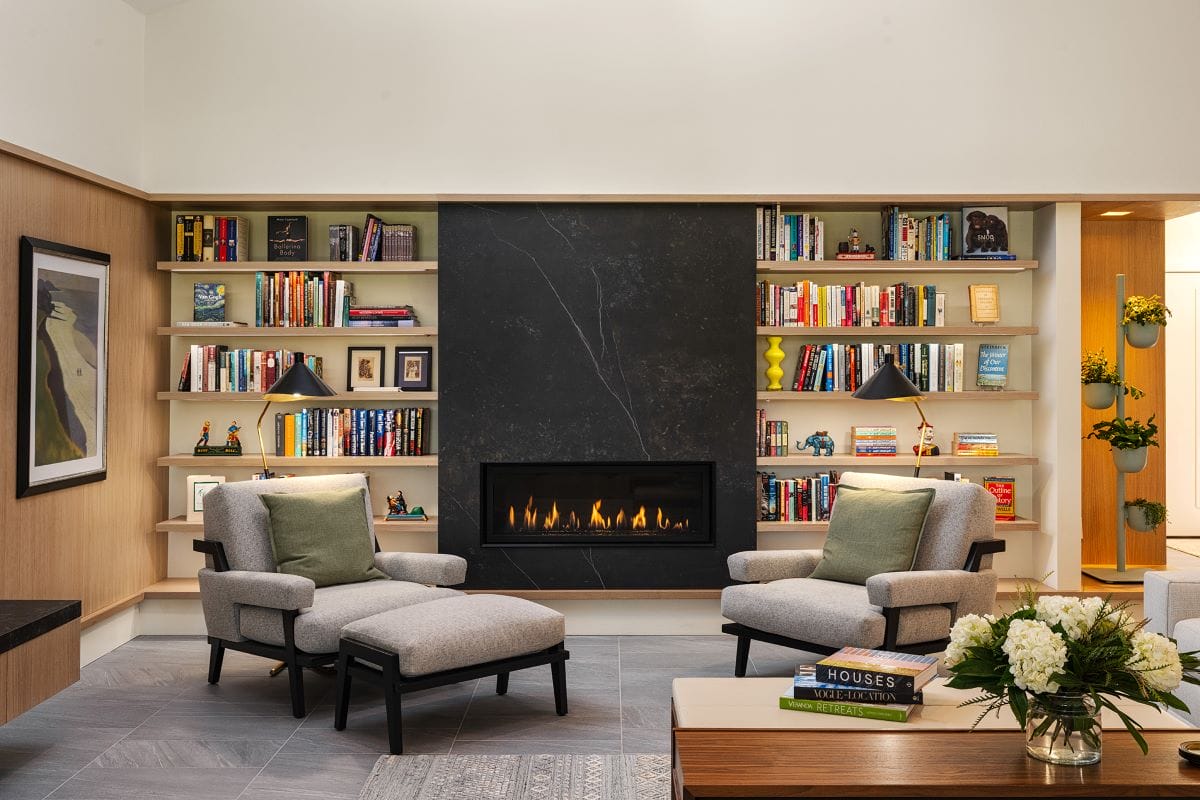A cozy reading corner in a family room interior by Decorilla