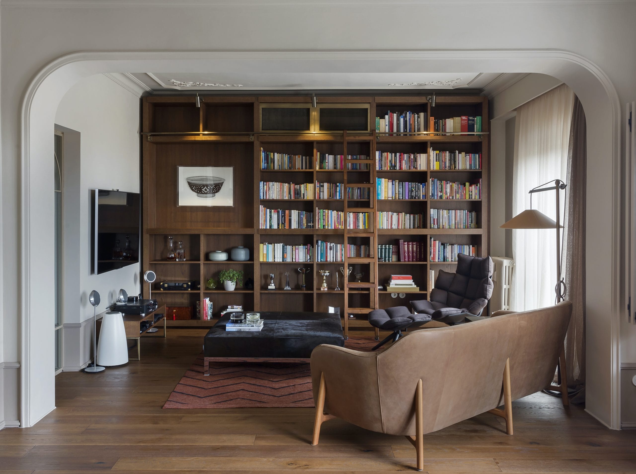 Furniture arrangement with a home library, design by Decorilla