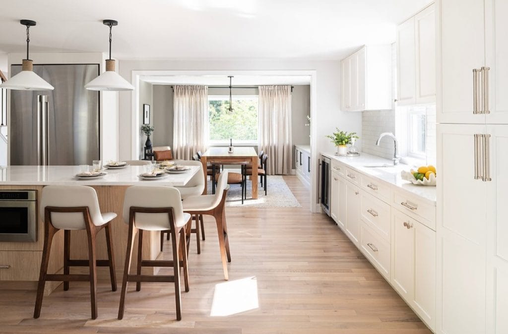 Kitchen with white cabinets and white countertops by Decorilla