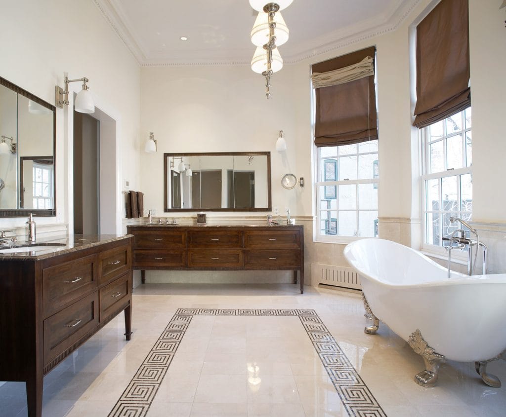 Modern clawfoot tub in a bathroom filled with vintage vibes by Decorilla