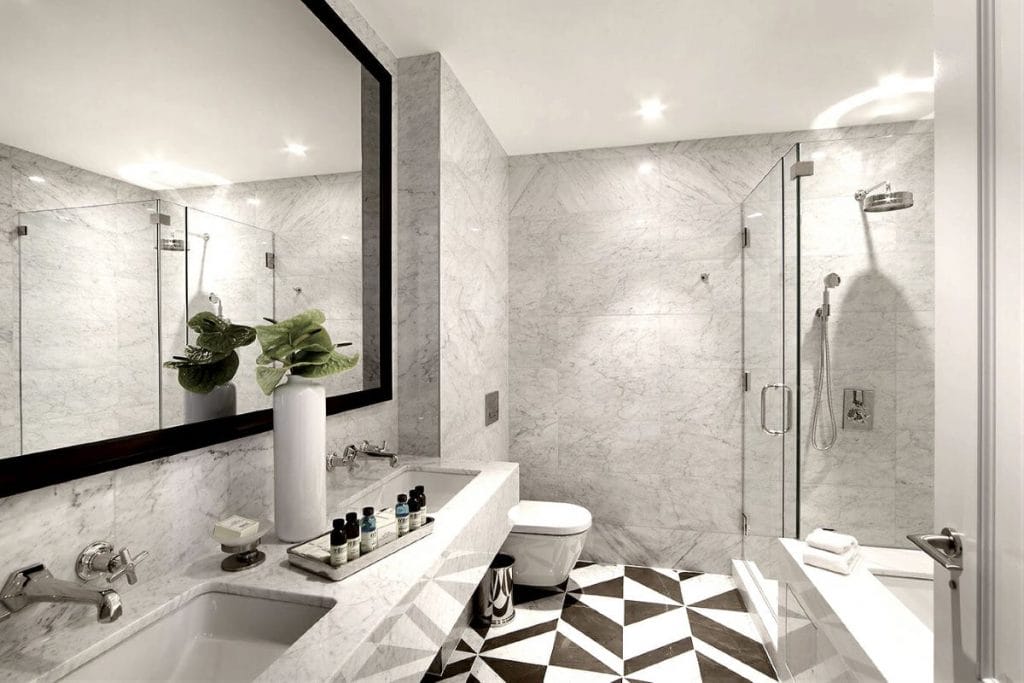 Modern tubs with showers offered as an option in a bathroom by Decorilla