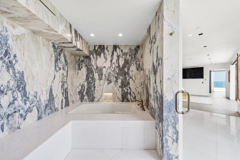 Modern version of classic bathroom luxury with a Roman style bathtub by Decorilla