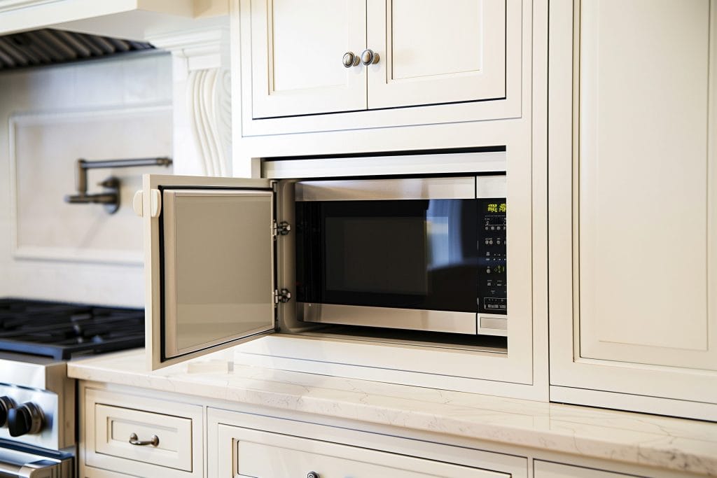 Custom appliance storage in a traditional kitchen by Decorilla