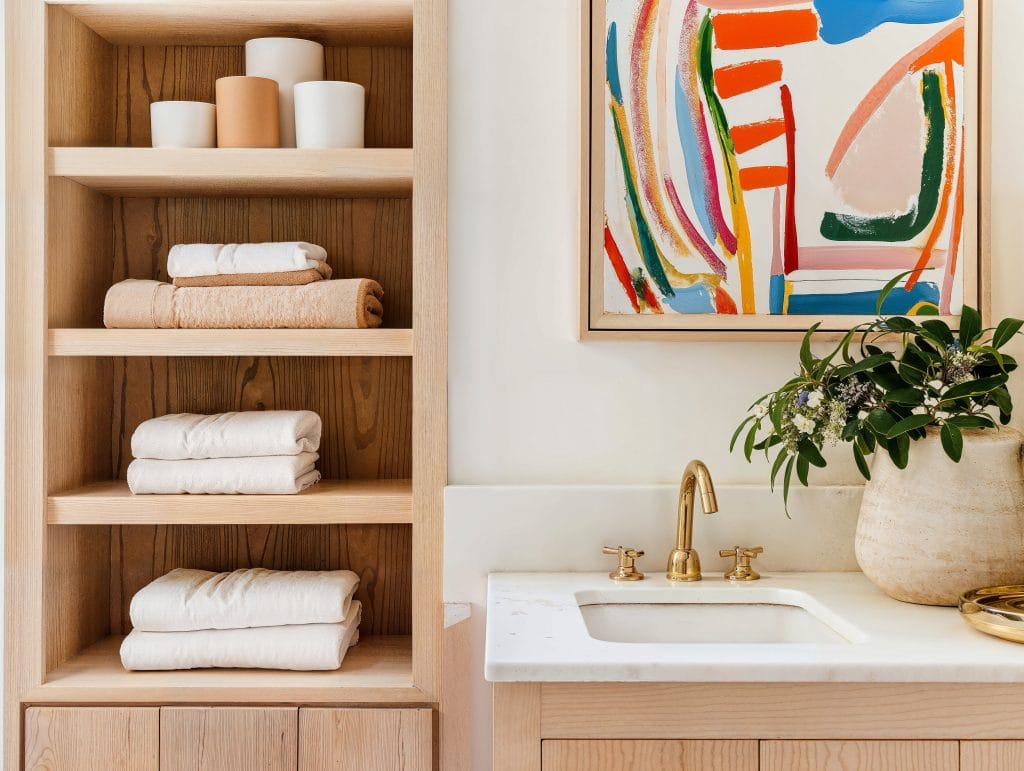 Integrating shelves with vanity in a bathroom by Decorilla