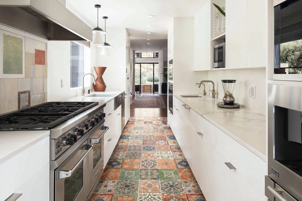 Kitchen embracing a retro revival with patterned vinyl tile, creatively designed by Decorilla