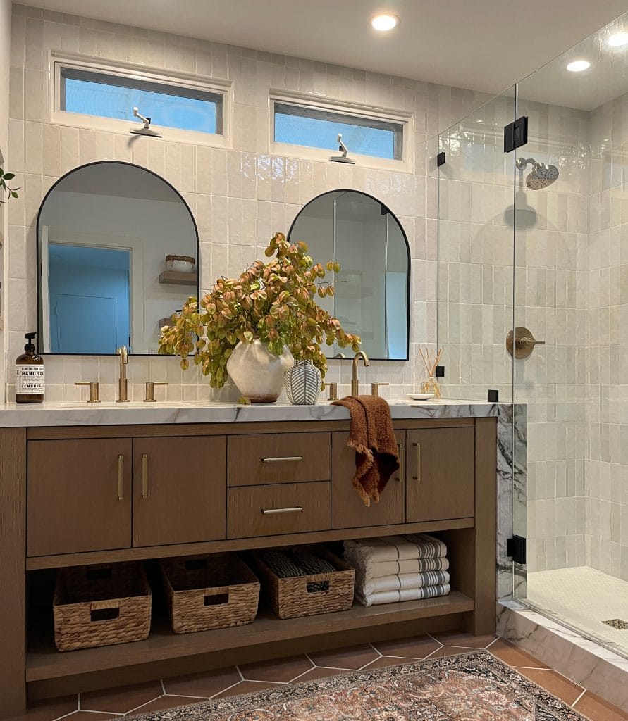 Contemporary bathroom with stone tile drenching design by DECORILLA designer, Bita T.