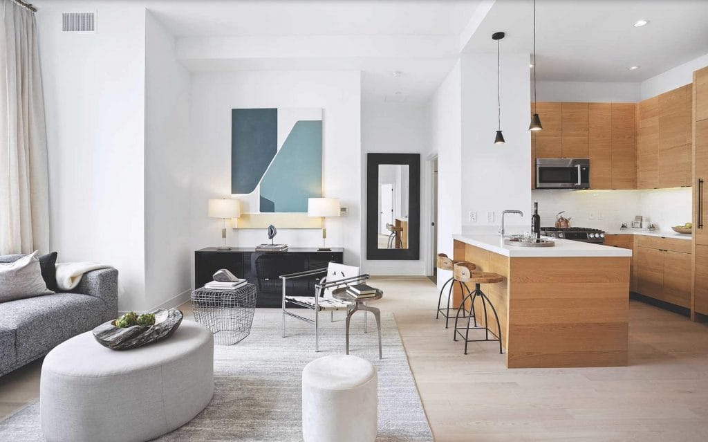 Open living space mixing wood tones with a neutral base by DECORILLA designer, Leanna S.