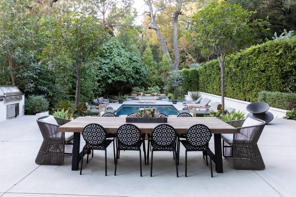 Outdoor dining area and pool lounge decorating ideas by Decorilla designer, Galina H.
