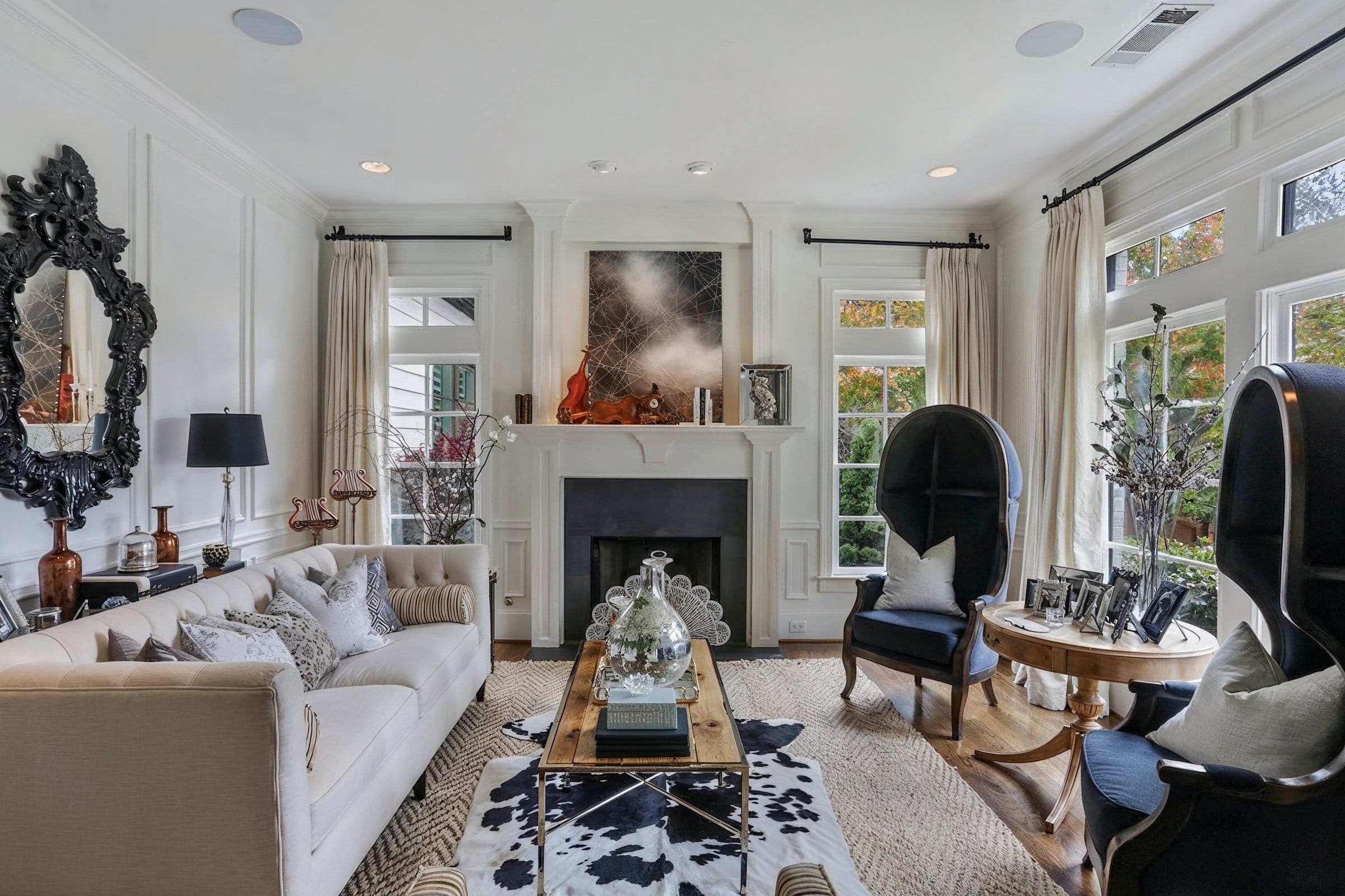 Transitional eclectic living room with cow print decor by Decorilla designer, Jason D.