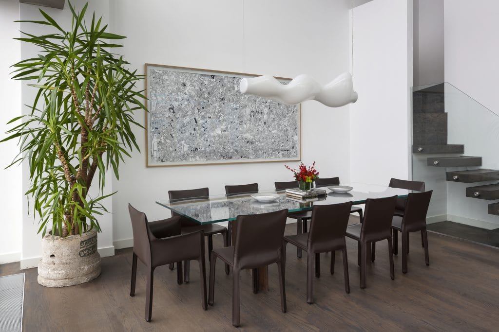 Contemporary dining room with statement wall art by DECORILLA designer, Meric S.