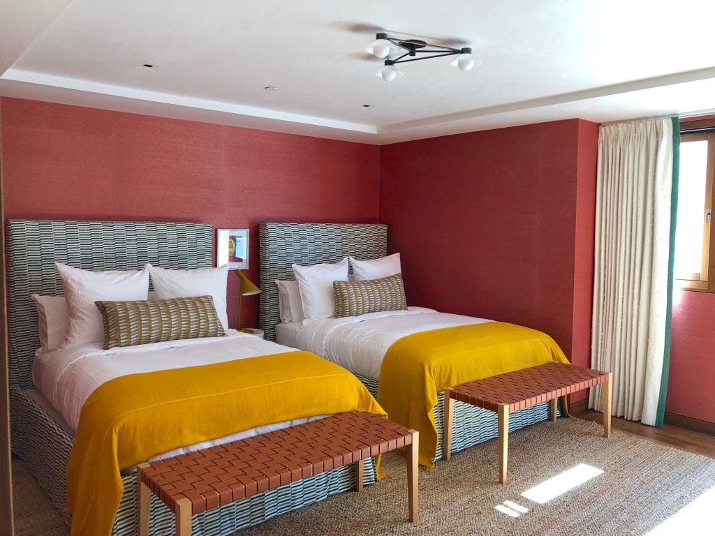 Modern guest bedroom with a corner bed placement by DECORILLA designer Brittany R