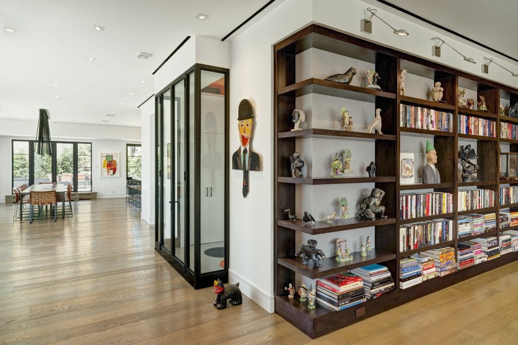 Modern hallway bookshelf with intentional clutter by DECORILLA designer, Susan W.