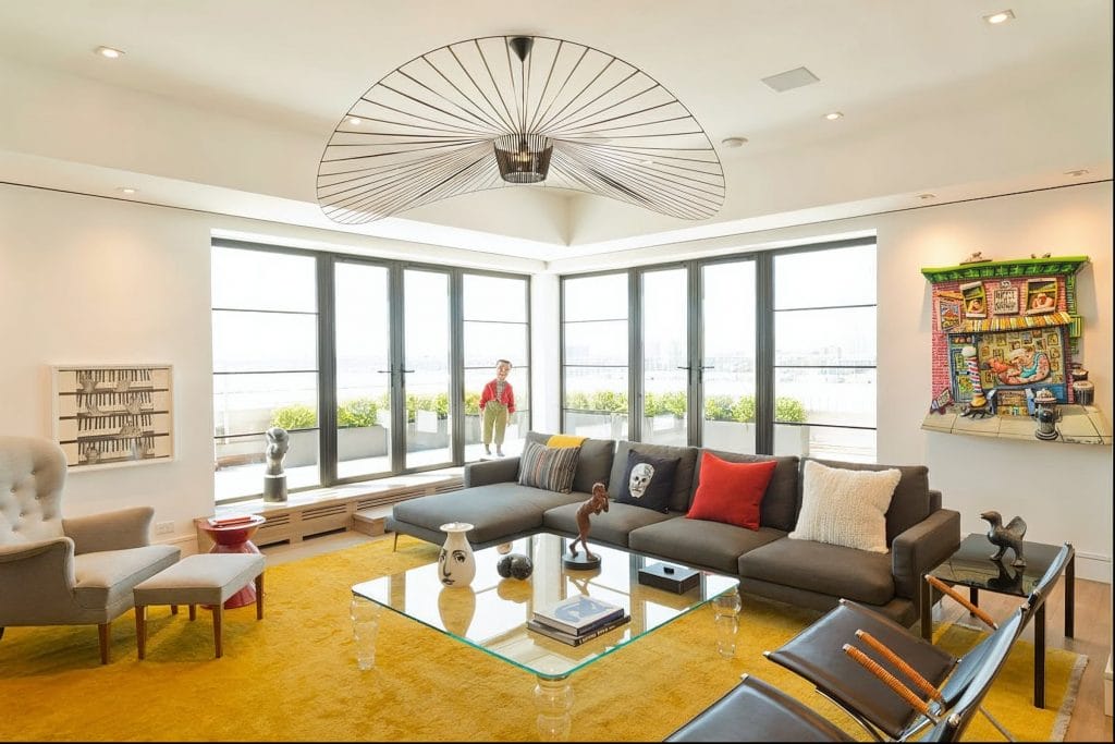 Eclectic living room with a bright yellow rug by Decorilla designer, Susan W. 