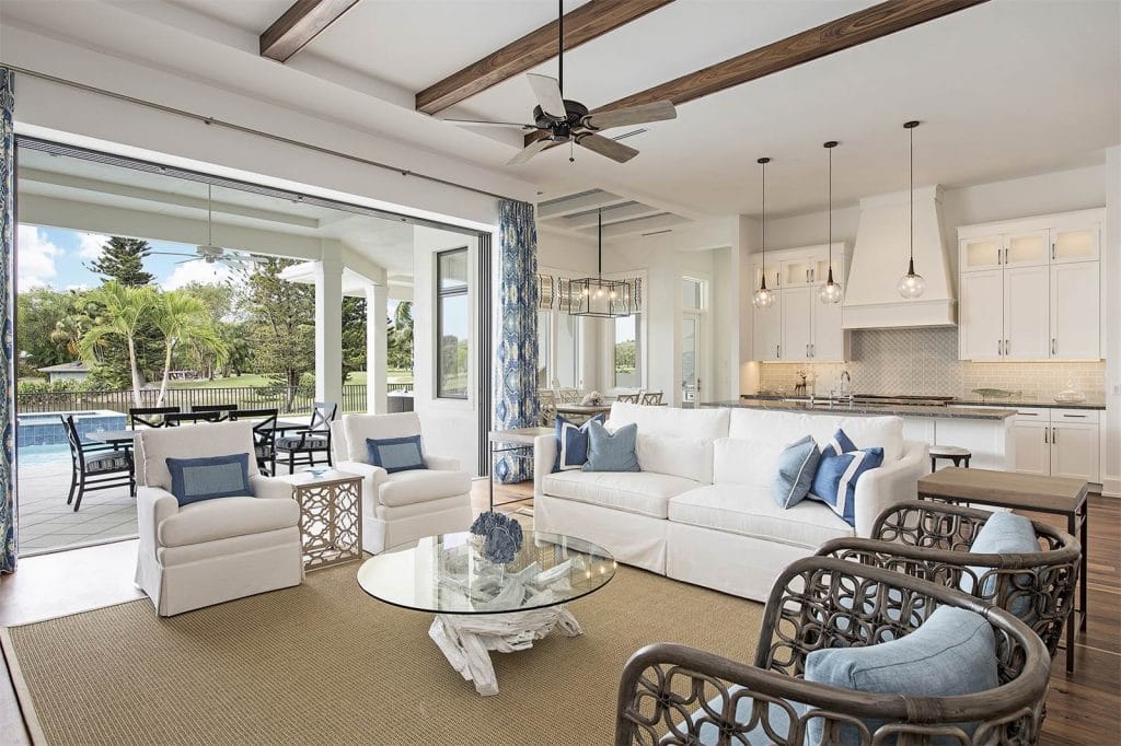 Skirted furniture in a broken floor plan coastal living room by Decorilla designer, Wanda P.