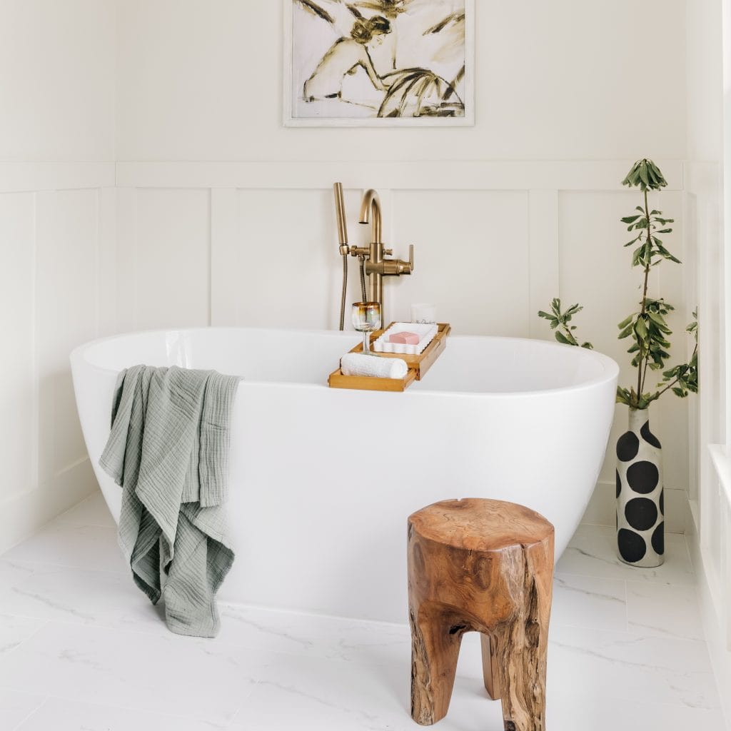 Trendy bathroom interior with a burl wood organic stool by Decorilla designer, Maja E.