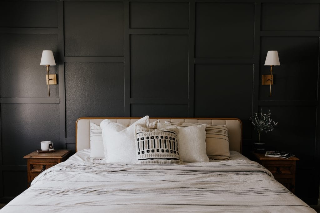 Charcoal limewash walls in a modern bedroom by Decorilla designer, Mackenzie H.